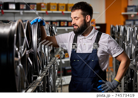 handsome caucasian adult auto mechanic man in uniform have rest 74573419