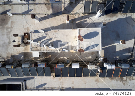 Solar panel and television antennas at the roof of building. 74574123
