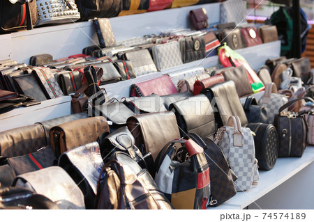 Showcase with fake handbags of famous brands. Showcase with fake handbags of famous brands. 74574189