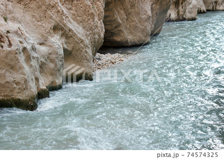 Water flowing through rock formations. 74574325