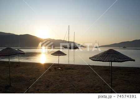 The harbor in the morning with mountains in the background. 74574391