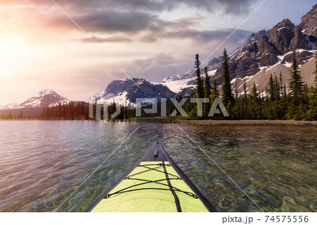 Kayaking in a glacier lake during a vibrant sunny summer morning. 74575556