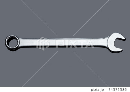 silver spanner wrench iron hand tool for repair and service plumbing instrument isolated on gray glass background with reflection top view, nobody. 74575586
