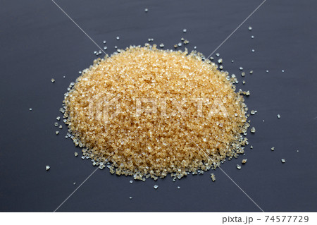 Cubes of sugar on dark background. 74577729