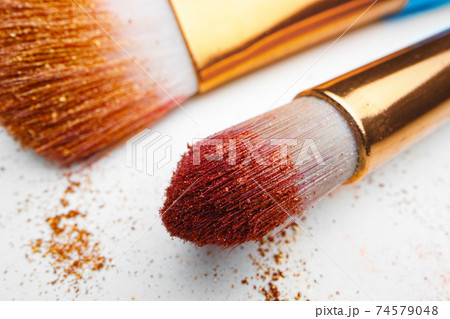 Make-up brush with powder on white background 74579048