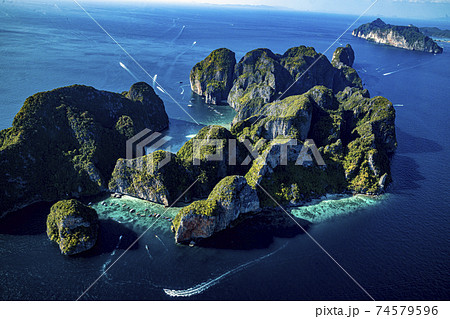 Top view of isolated rocky tropical island with turquoise water and white beach. 74579596