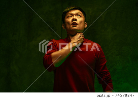 Coronavirus infected Chinese man suffocating. Close up portrait Coronavirus infected Chinese man suffocating. Close up portrait 74579847