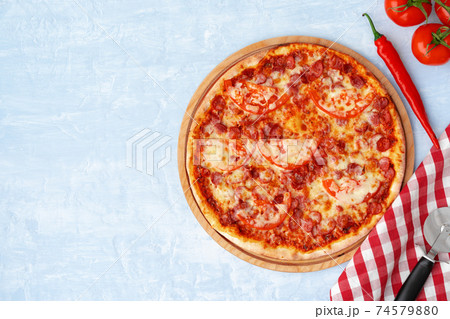 Delicious pizza with sausages on gray background 74579880