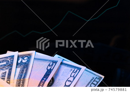 American dollar banknotes and graph on black background 74579881