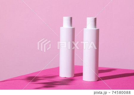 Skincare products containers on bright pink background Skincare products containers on bright pink background 74580088