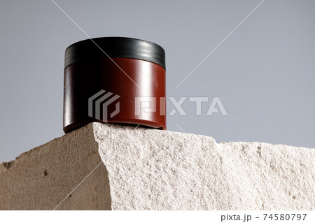 Skincare cosmetic jar on gray cinder block Skincare cosmetic jar on gray cinder block 74580797
