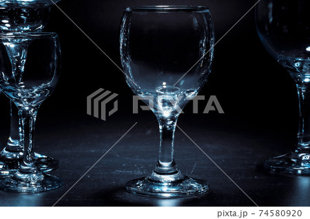 Empty glasses for drinks on dark background 74580920