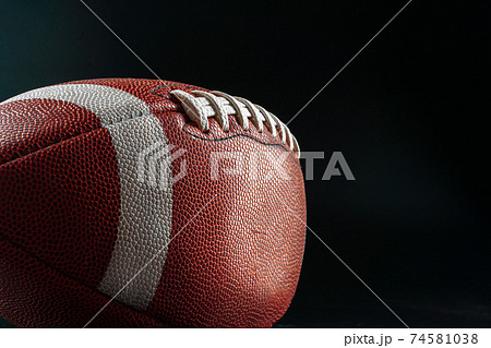 American foottball ball on dark background close up 74581038