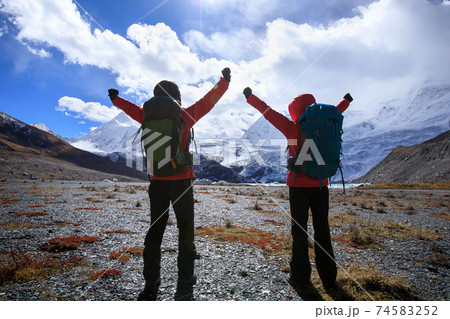 Two women hikers hiking  in winter mountains 74583252