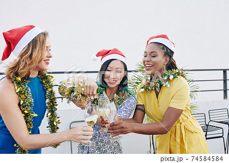 Friends filling champagne glasses 74584584