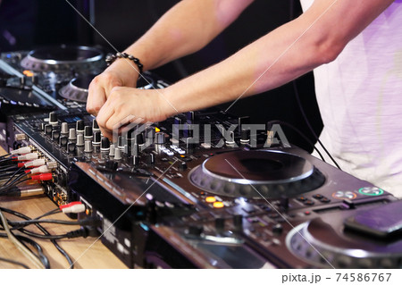 DJ playing music on digital mixer controller 74586767