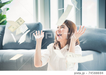 Happy young asian woman holding dollar money and throw in the air celebrate happiness dance Happy young asian woman holding dollar money and throw in the air celebrate happiness dance 74588694