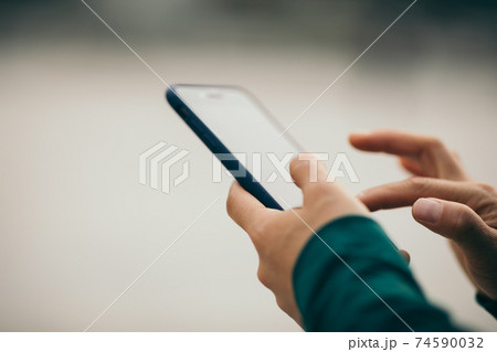Asian woman using smartphone outdoors Asian woman using smartphone outdoors 74590032