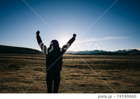 Backpacking female hiker hiking in sunrise high altitude mountains Backpacking female hiker hiking in sunrise high altitude mountains 74590660