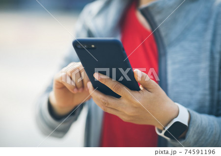 Asian woman using smartphone at city Asian woman using smartphone at city 74591196