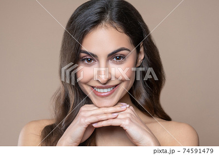 Happy young long-haired woman with beautiful smile 74591479
