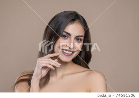 Long haired young woman with bare shoulders 74591506