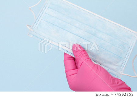 Dentist's hand in glove with protective mask. Dentist's hand in glove with protective mask. 74592255