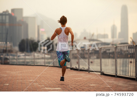 Healthy lifestyle woman runner running on hong kong city Healthy lifestyle woman runner running on hong kong city 74593720