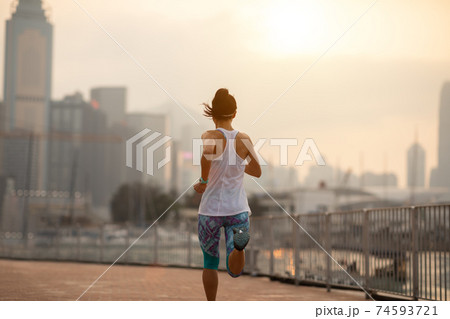Healthy lifestyle woman runner running on hong kong city Healthy lifestyle woman runner running on hong kong city 74593721