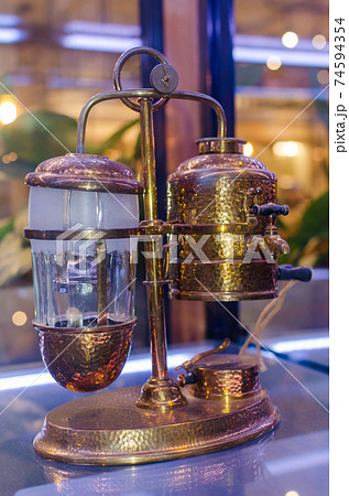 Retro coffee machine of 1900-1915 years. When the temperature rises, the water in the glass jug is pulled to the other side. Retro coffee machine of 1900-1915 years. When the temperature rises, the water in the glass jug is pulled to the other side. 74594354