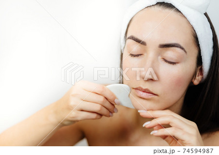 woman using gouache scraper massager woman using gouache scraper massager 74594987