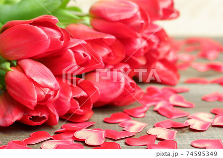 Bouquet of red tulips, silk red hearts on brown wooden planks table close up view selective focus. Spring holidays, Womens, spring, love, romantic, flowers, garden, Easter card, banner, template Bouquet of red tulips, silk red hearts on brown wooden planks table close up view selective focus. Spring holidays, Womens, spring, love, romantic, flowers, garden, Easter card, banner, template 74595349