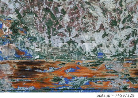 Polished and abraded paint on an old wooden wall of a boat. 74597229
