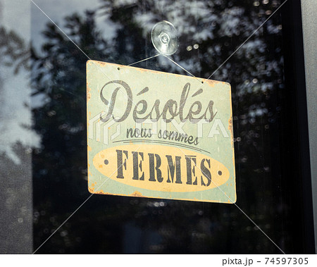 Sign on shop window reads 'sorry, we are closed', in France Sign on shop window reads 'sorry, we are closed', in France 74597305