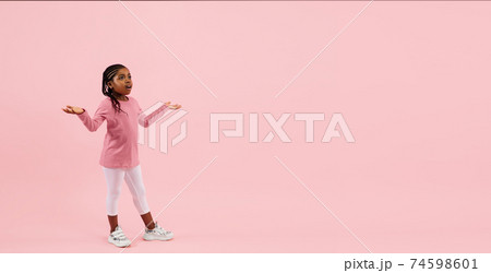 Childhood and dream about big and famous future. Pretty little girl isolated on coral pink background Childhood and dream about big and famous future. Pretty little girl isolated on coral pink background 74598601
