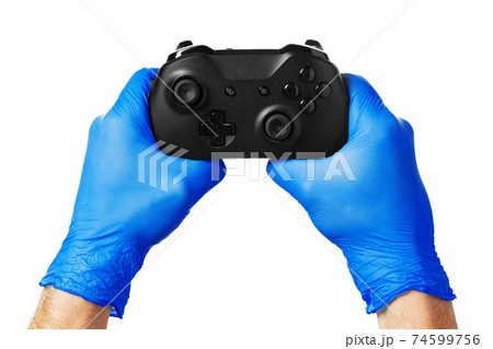 Video game console controller in gamer gloved hands. Games during isolation at home 74599756