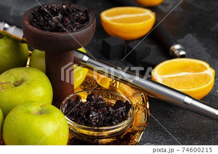 Shisha parts with apples and lemons on table 74600215