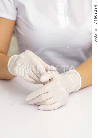 Two hands in protective gloves 74603234