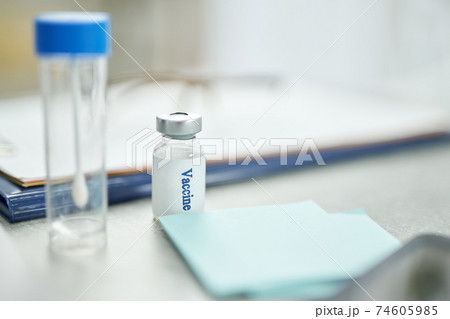Test tube and bottle of vaccine on table in clinic Test tube and bottle of vaccine on table in clinic 74605985
