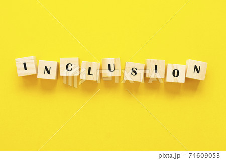 Inclusion concept word on wooden cubes on yellow background 74609053