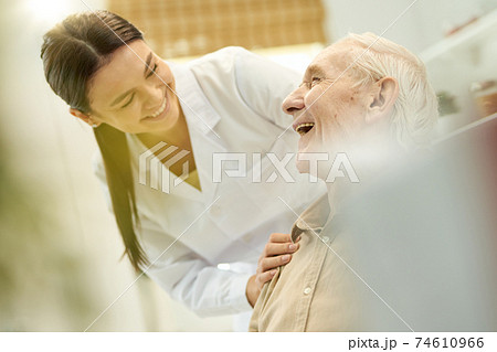 Friendly medic smiling at the senior citizen in her care Friendly medic smiling at the senior citizen in her care 74610966