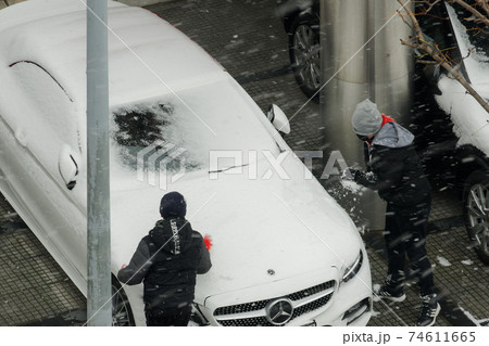 Thessaloniki, Greece Children playing during snowfall outdoors. 74611665