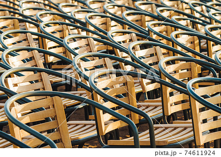 Wooden chairs. Empty stools without people. Concept photo - absence of audience. Wooden chairs. Empty stools without people. Concept photo - absence of audience. 74611924