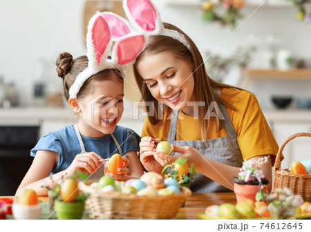 Happy easter! family: mother and child with ears hare getting ready for holiday 74612645
