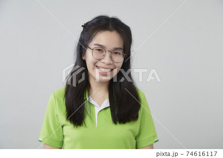 Asian woman portrait with a green shirt Asian woman portrait with a green shirt 74616117