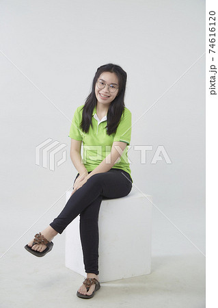 Asian woman portrait with a green shirt Asian woman portrait with a green shirt 74616120