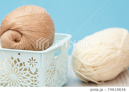 Woolen yarn for knitting. Balls of natural wool yarn. 74619636