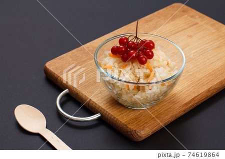 Fermented cabbage with herbs and spices in glass bowl on the black background Fermented cabbage with herbs and spices in glass bowl on the black background 74619864
