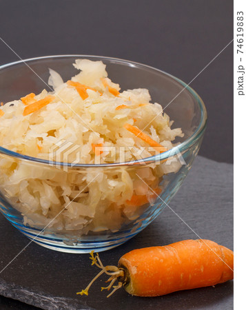 Fermented cabbage with herbs and spices in glass bowl on the black background Fermented cabbage with herbs and spices in glass bowl on the black background 74619883