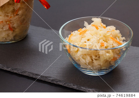 Fermented cabbage with herbs and spices in glass bowl on the black background Fermented cabbage with herbs and spices in glass bowl on the black background 74619884